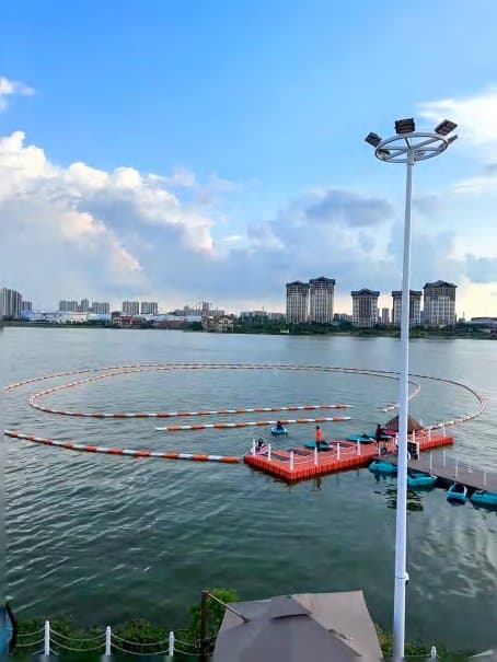 City-lake operator venue with a circular buoy track and floating docks