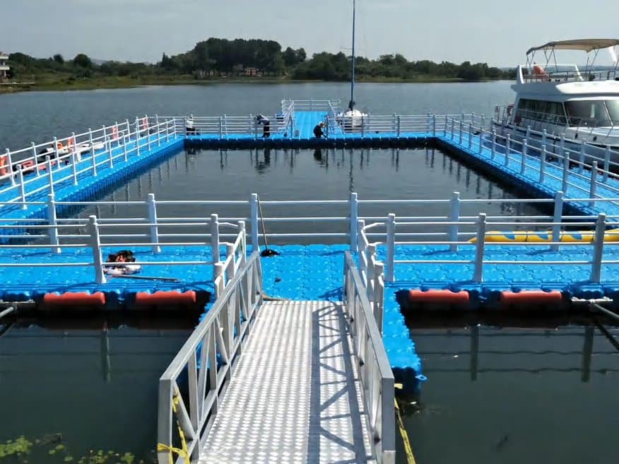 Blue modular floating dock with leisure-boat berths at a waterfront venue